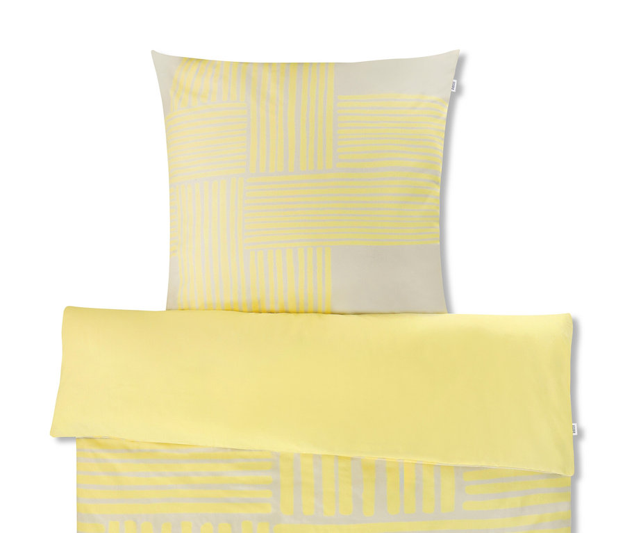 Gelbe Bettwäsche mit geometrischem Muster.