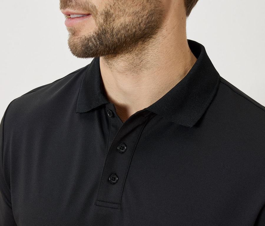 Nahaufnahme eines Mannes mit Bart, der ein schwarzes Poloshirt trägt.