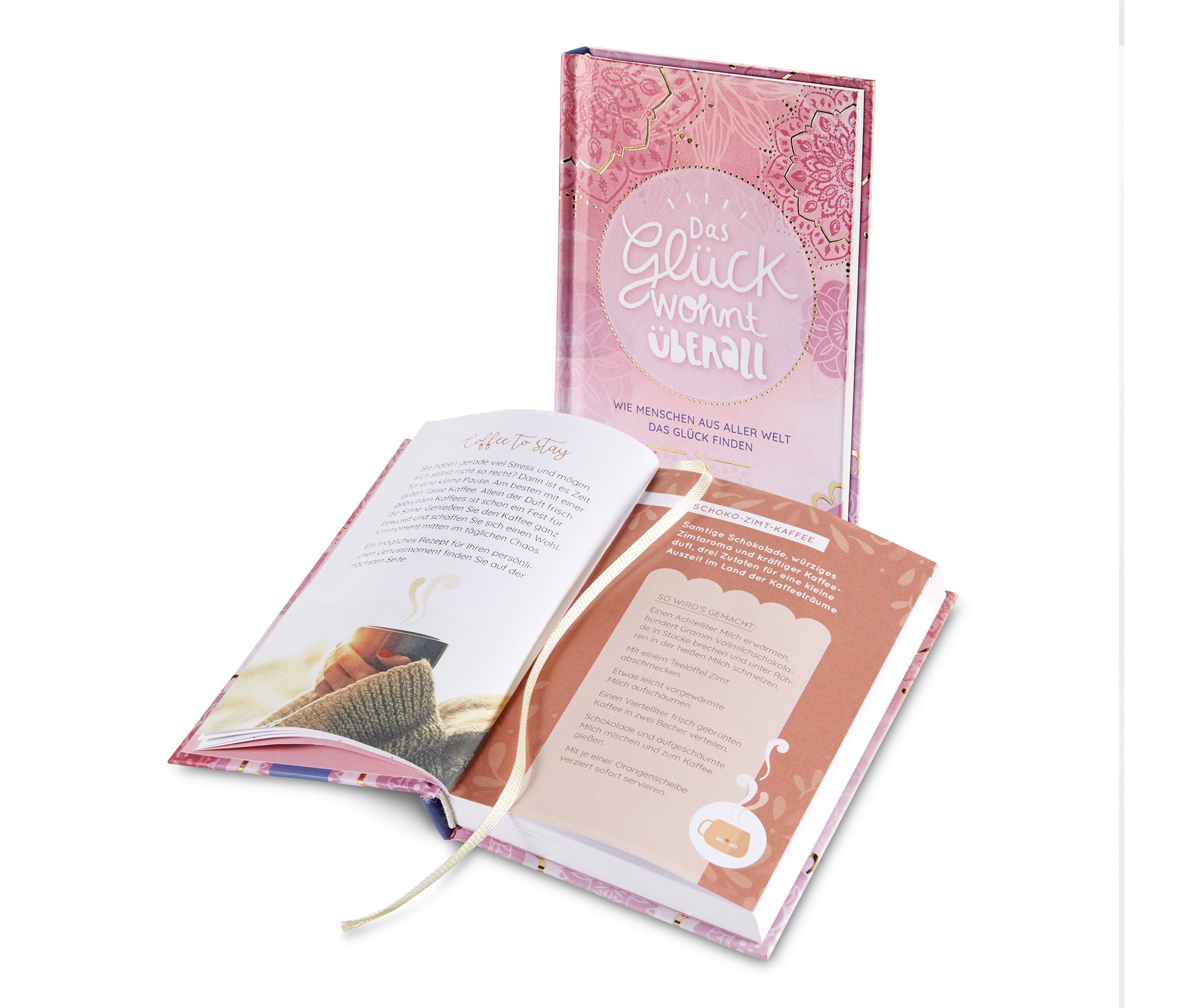 Zwei Ausgaben des Buches »Das Glück wohnt überall« werden gezeigt, wobei ein offenes Buch im Vordergrund steht.