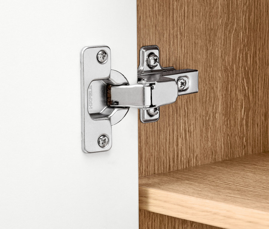 Detail eines silbernen Scharniers an einem weißen Highboard »Bekeson«.