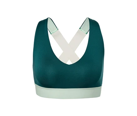 Grünes Sport-Bustier mit gekreuzten Trägern.