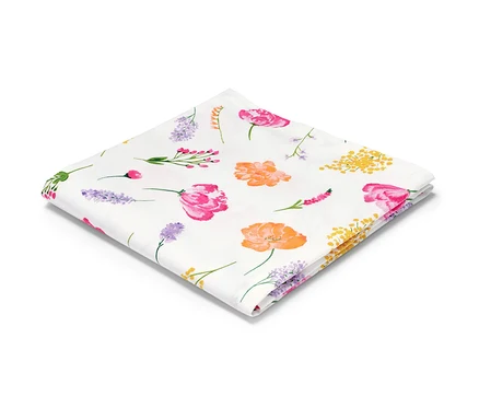 Eine gefaltete Baumwoll-Tischdecke mit Blumenmuster.