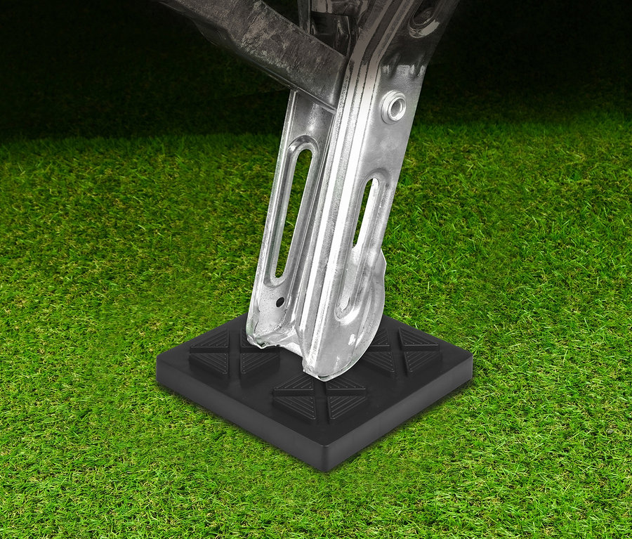 Eine silberne Stütze steht auf einem schwarzen 10-teiligen EAL Ausgleichskeil-Set auf Gras.