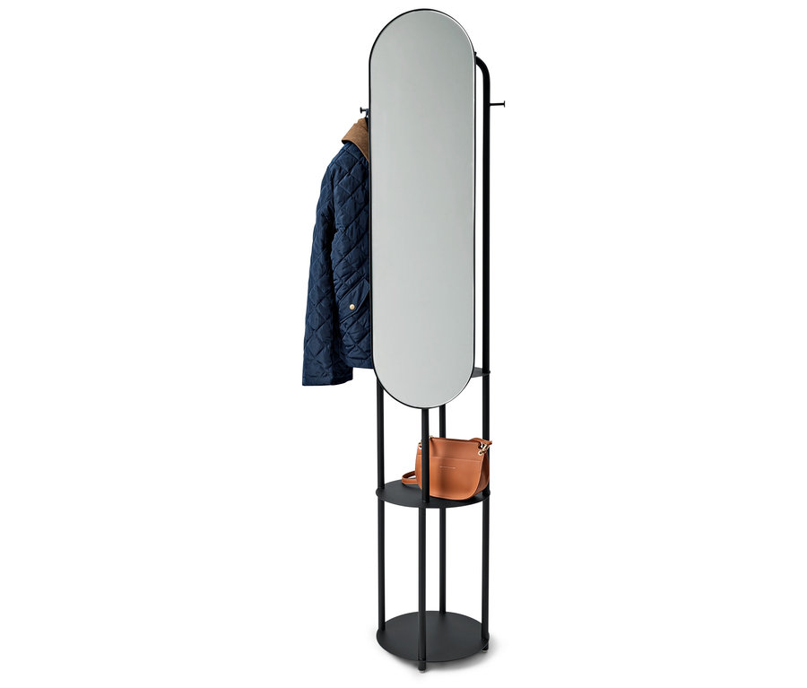 Schwarzer Ständer mit ovalem Spiegel, eine blaue Jacke und eine braune Handtasche.