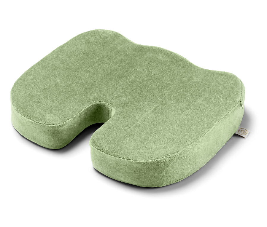 Ein grünes Sitzkissen mit einer Aussparung in der Mitte.