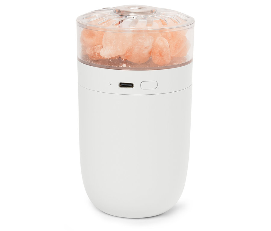 Weiße Lampe mit rosa Salzkristallen in einem transparenten Oberteil.