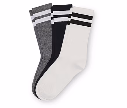 Drei Paar Socken in Grau, Schwarz und Weiß liegen übereinander. Jedes Paar hat zwei Streifen am oberen Rand.