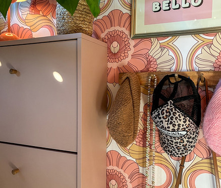 Aprikotfarbener Schuhschrank »Bjarne« mit drei Klappen. Auf dem Schrank steht eine Pflanze in einem Korb.