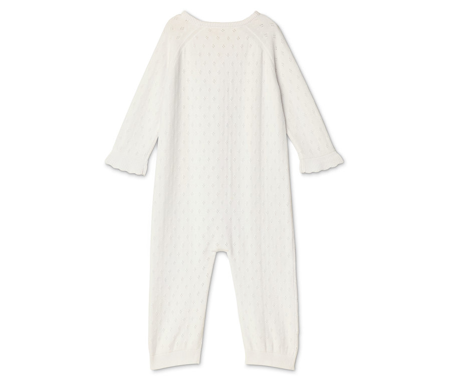 Ein weißer Baby-Overall mit langen Ärmeln und Beinen liegt auf einem weißen Hintergrund.