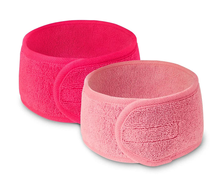 Zwei Kosmetik-Stirnbänder, eines pink und eines hellrosa.
