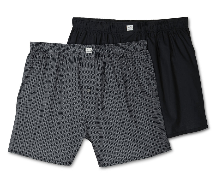 Zwei Web-Boxershorts, eine grau gemustert, eine schwarz.