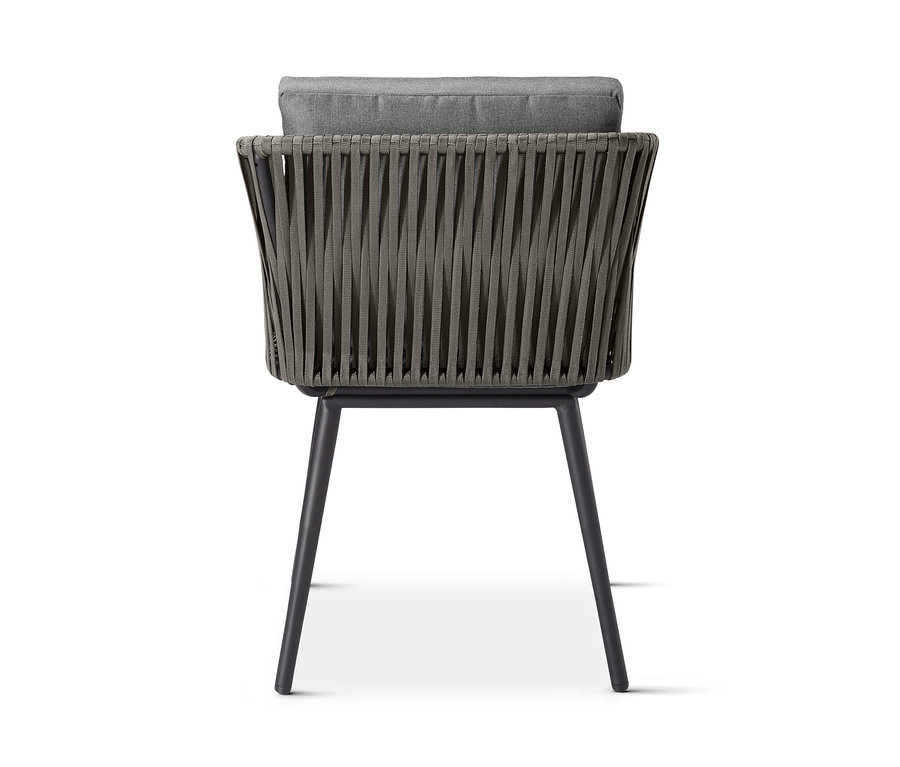 Rückansicht des Dining-Sessels »Jara« mit Textilgeflecht und grauem Kissen.