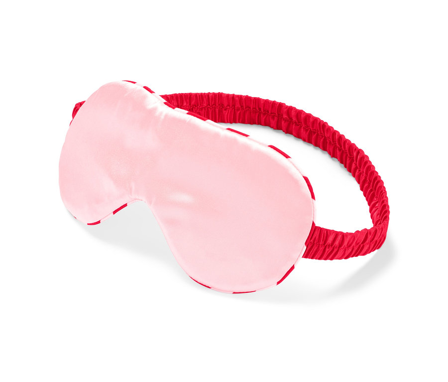 Eine rosa Schlafmaske mit einem roten Gummiband.