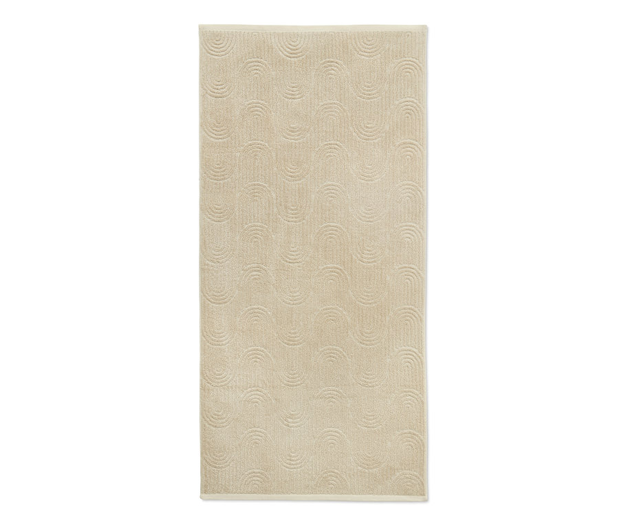 Ein cremefarbenes Jacquard-Badetuch mit erhabenem Halbkreis-Muster.