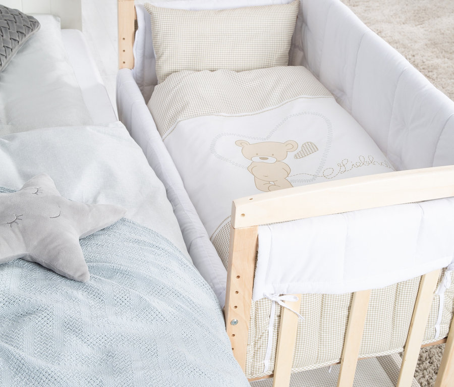 Ein roba 4-in-1-Stuben-Beistellbett »Liebhabär« steht neben einem Bett.