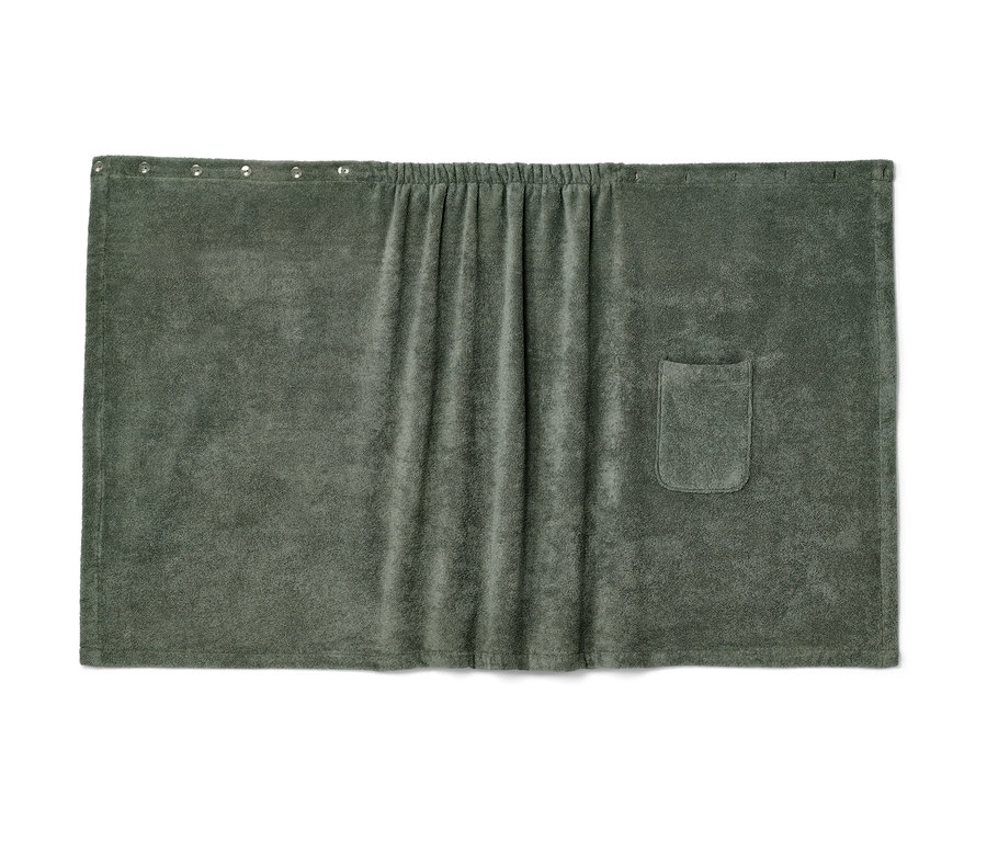 Ein grüner Damen-Saunakilt mit Tasche und Gummibund liegt flach.