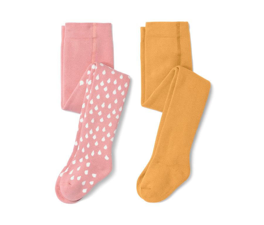 Zwei Kleinkind-Thermostrumpfhosen, eine rosa mit weißen Tropfen, eine gelb.