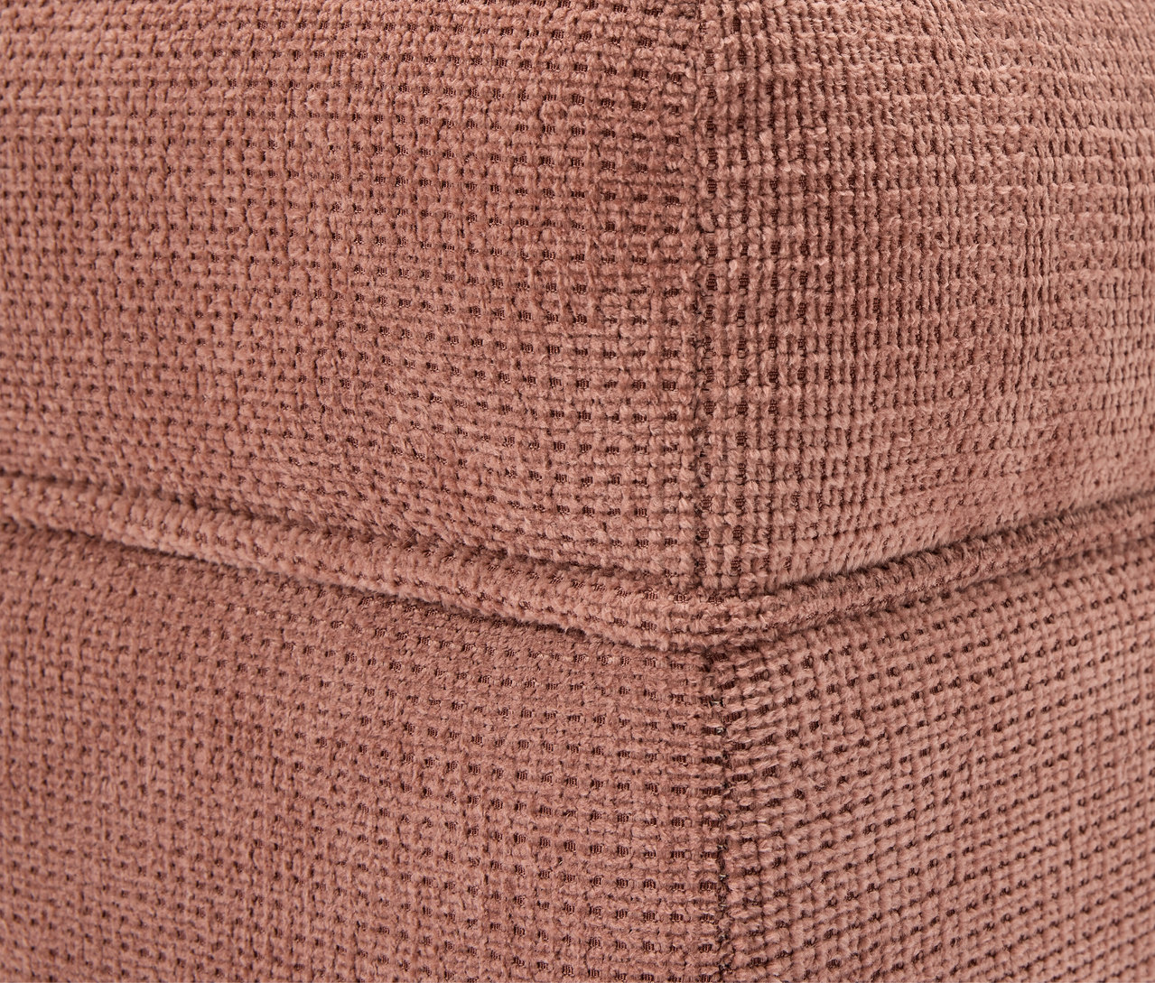 Detail einer Ecke eines braunen Stoffwürfels.