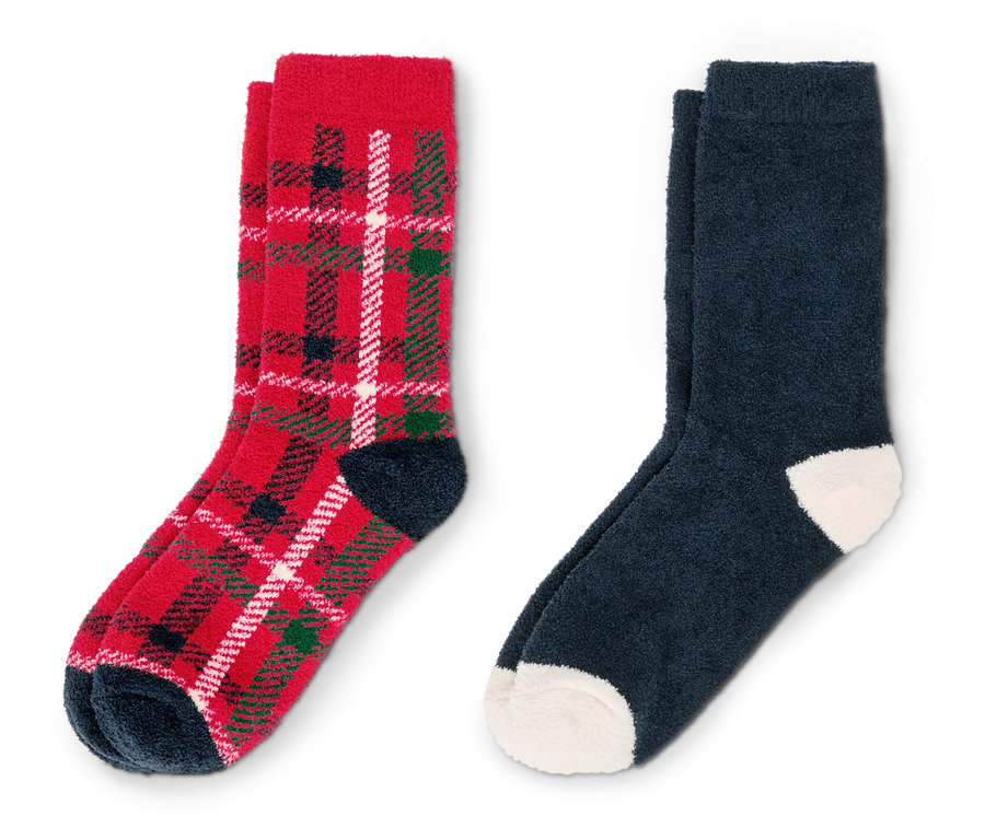 Zwei Paar Socken. Ein Paar ist rot mit Tartanmuster und das andere Paar ist dunkelblau.
