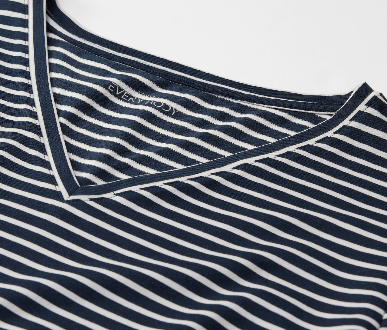 Detailaufnahme eines blau-weiß gestreiften T-Shirts mit V-Ausschnitt.