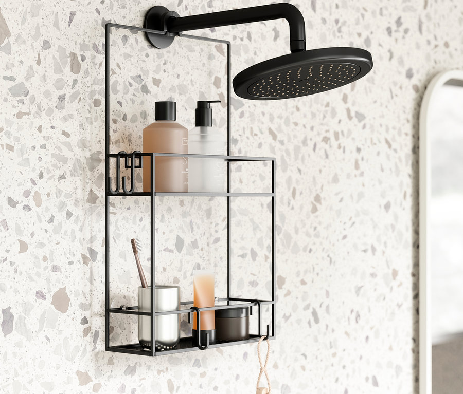 Ein hängendes Duschregal mit Shampoo, Zahnbürste und Becher an einer Badezimmerwand.