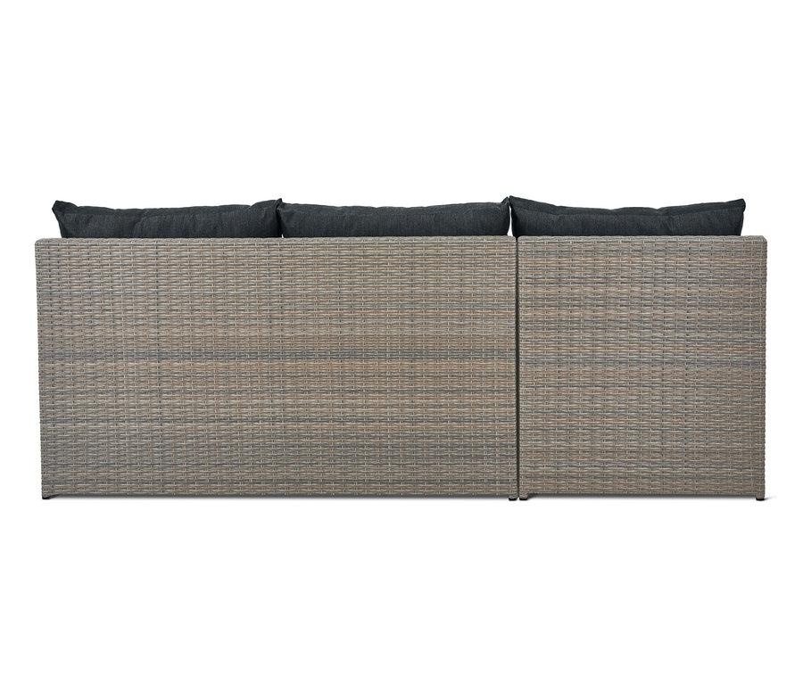 Detailansicht des Lounge-Schlafsofas »Thore« mit Ausziehfunktion und dunklen Kissen.