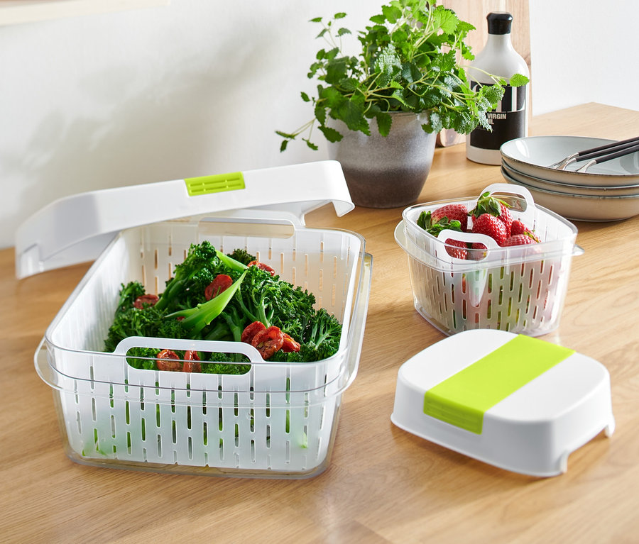 Zwei Rotho Klimabox-Sets stehen auf einem Tisch, eines mit Brokkoli und eines mit Erdbeeren.