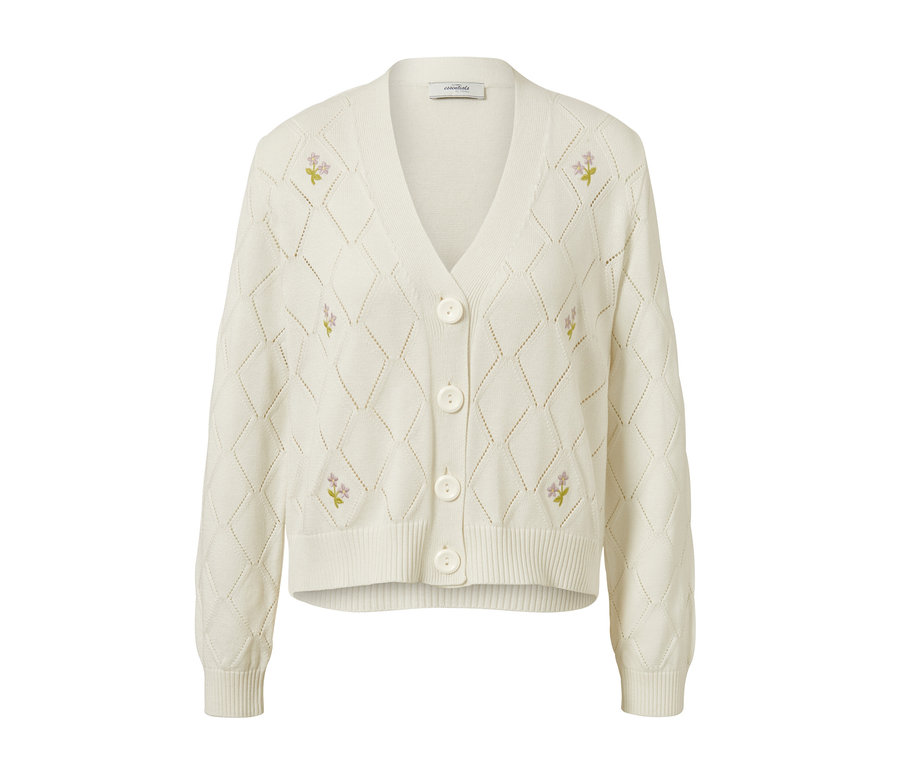 Ein weißer Cardigan mit Blumenstickerei.