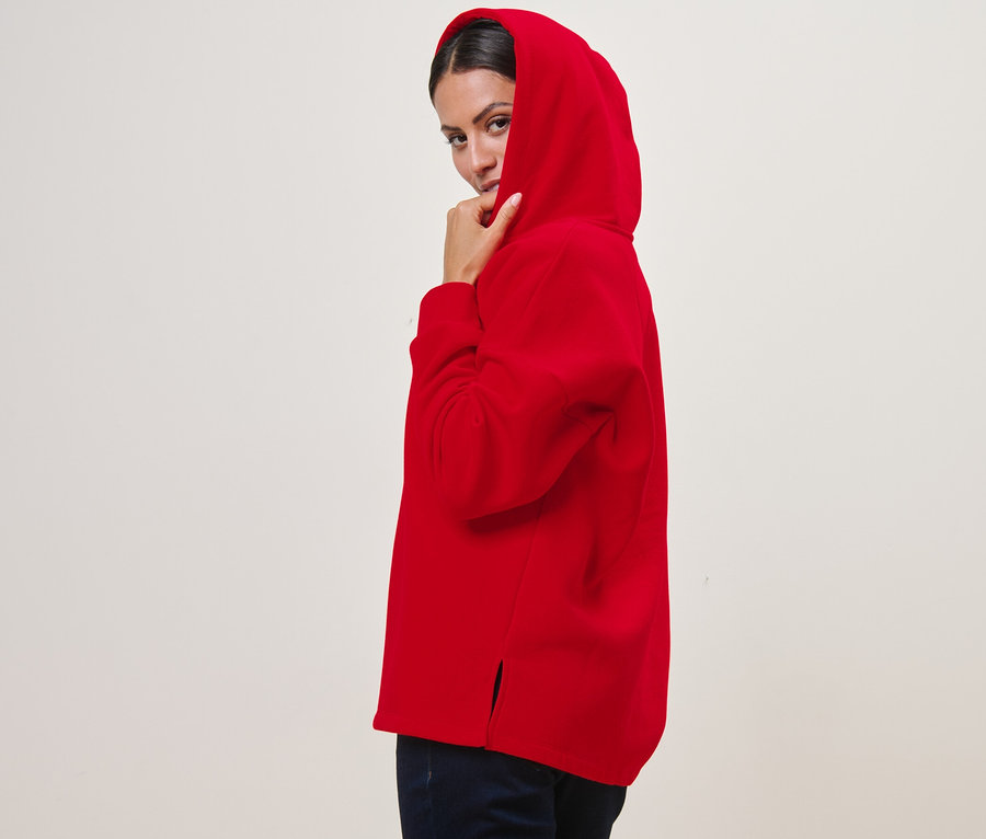 Frau posiert in rotem Hoodie.