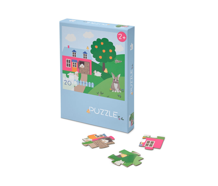 Eine Packung des »Ostern« Puzzles, mit einigen Puzzleteilen darunter ausgelegt.