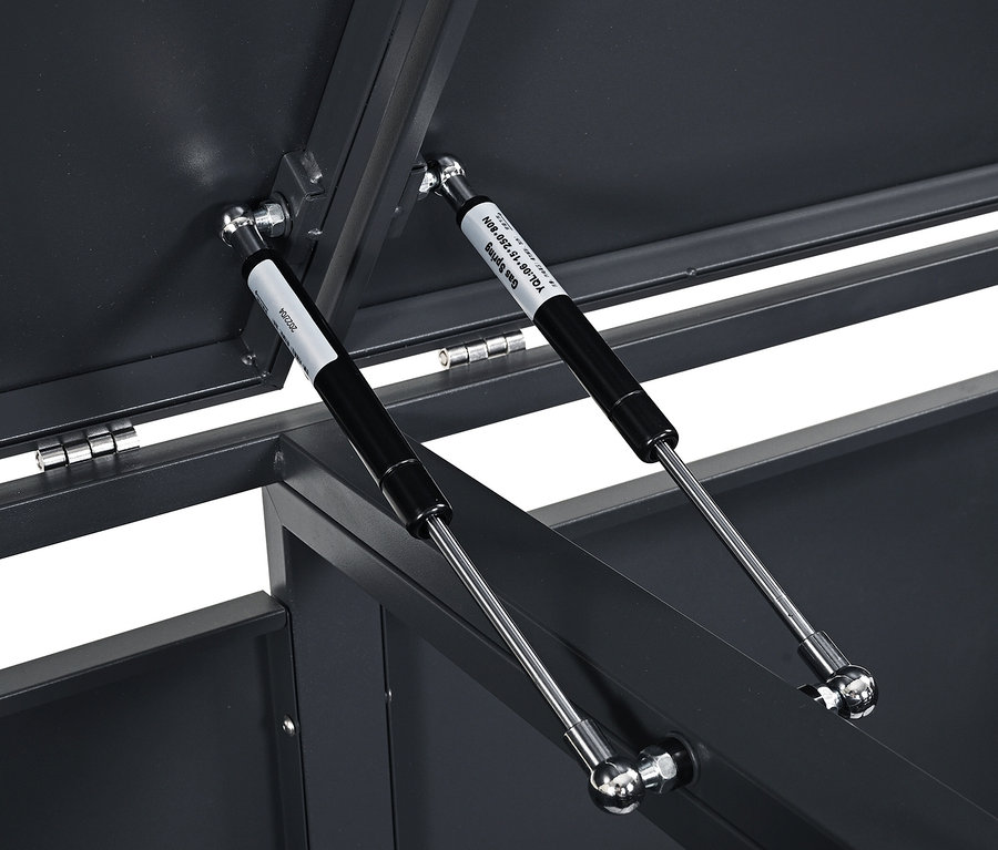 Detailaufnahme des Inneren eines geöffneten grauen Behälters, der zwei Gasdruckfedern zeigt.