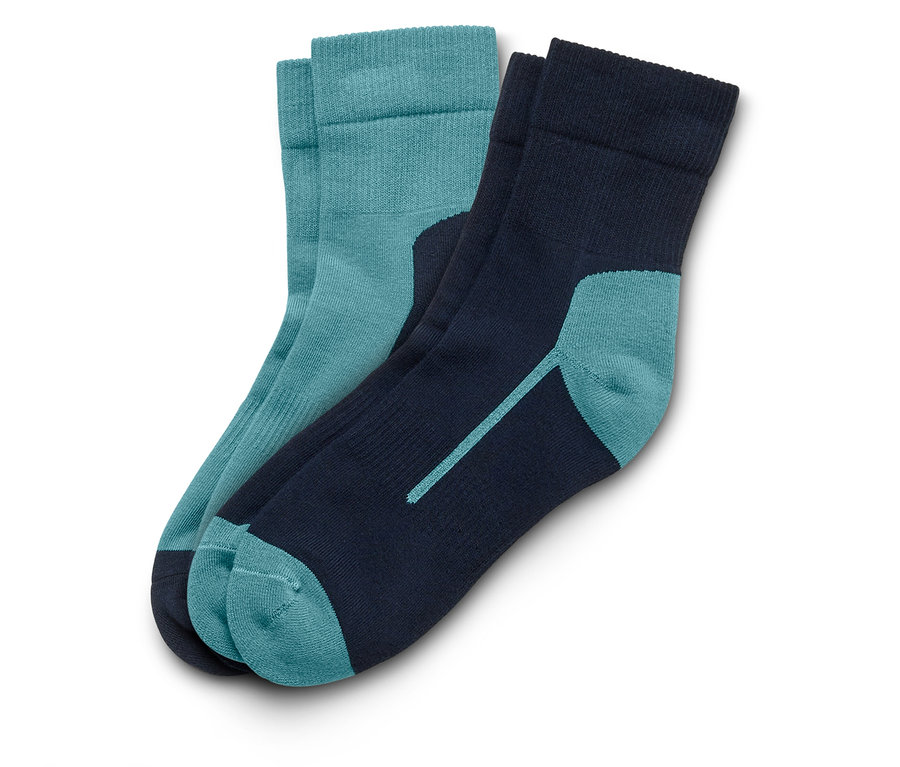 Zwei Socken liegen auf einem weißen Hintergrund. Eine Socke ist blaugrün, die andere marineblau mit blaugrünen Akzenten.