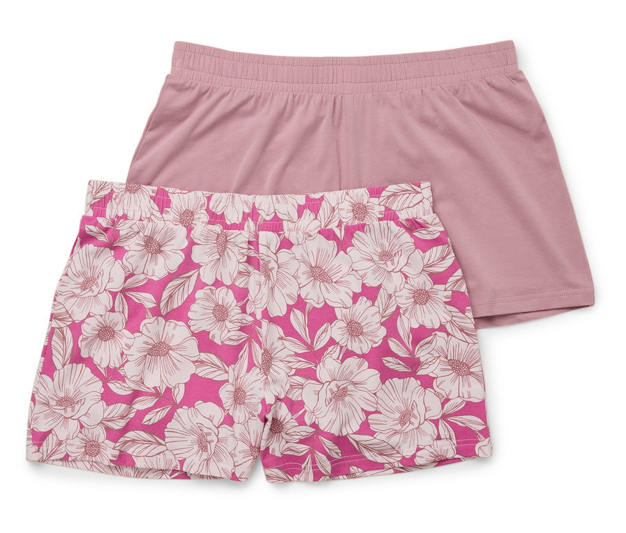 Zwei kurze Hosen liegen übereinander: eine unifarben rosa, die andere rosa mit weißem Blumenmuster.