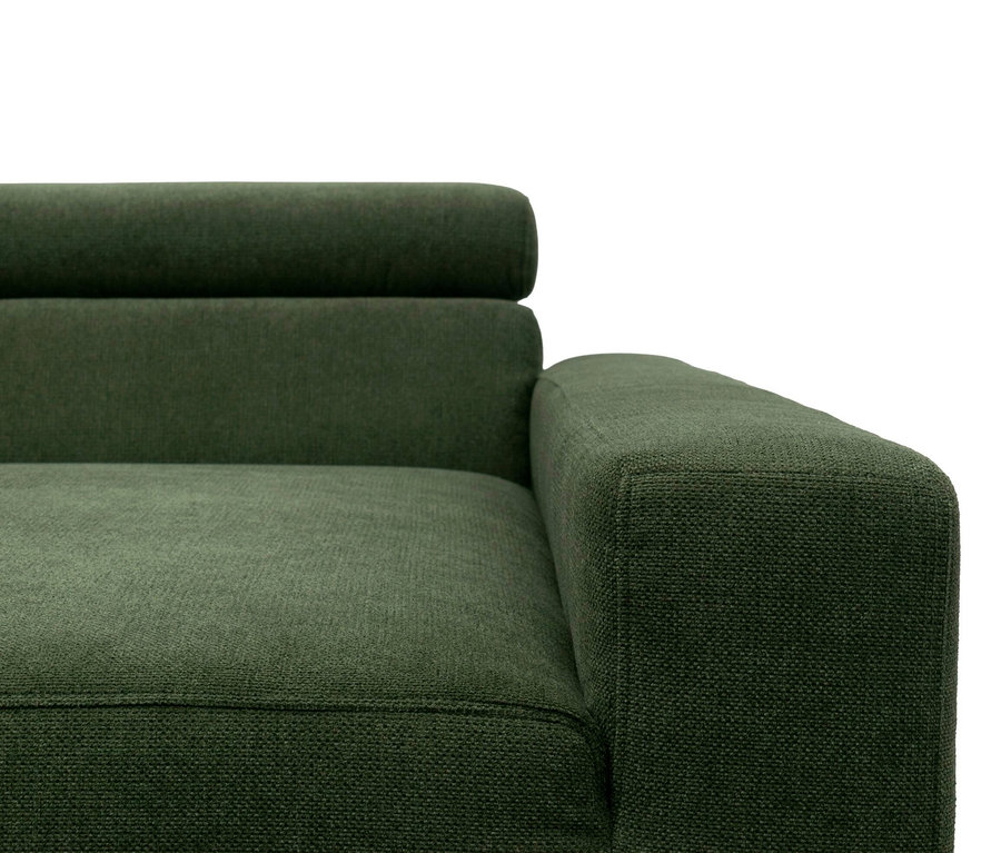 Nahaufnahme eines dunkelgrünen Stoffsofas, das die rechte Armlehne, einen Teil der Sitzfläche und die Rückenlehne zeigt. Der Stoff hat eine sichtbare Webstruktur.