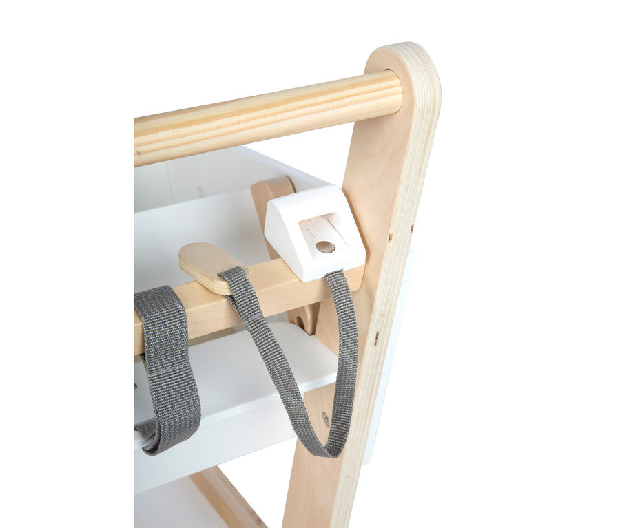 Nahaufnahme eines hellen Holz- und weißen Hochstuhls, mit grauen Stoff-Sicherheitsgurten, die an einer horizontalen Holzstange mit einer weißen Schnalle befestigt sind.
