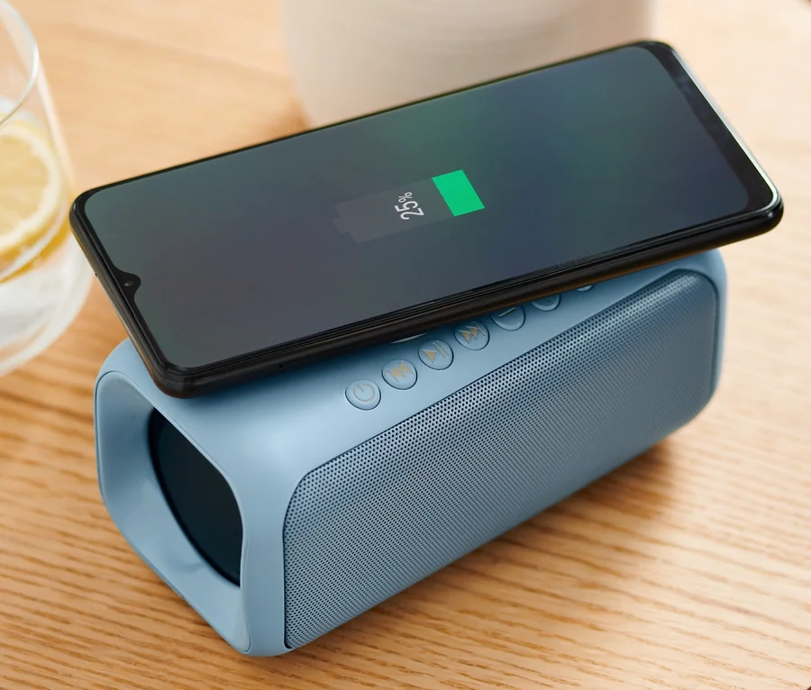 Handy wird auf Lautsprecher mit Qi-Charging geladen.