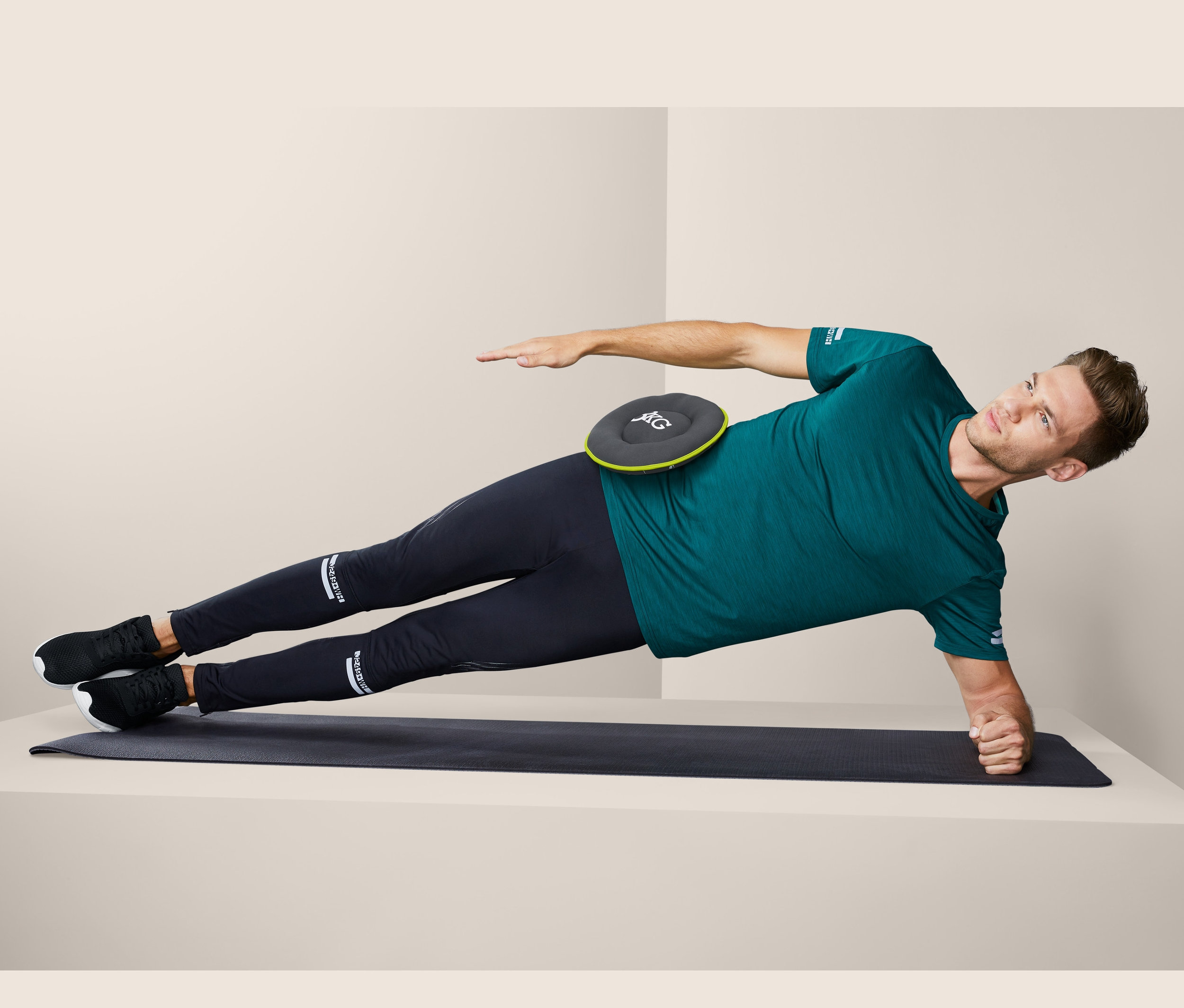 Mann im Seitstütz mit zwei Soft-Hantelscheiben, je ca. 3 kg, auf der Hüfte.