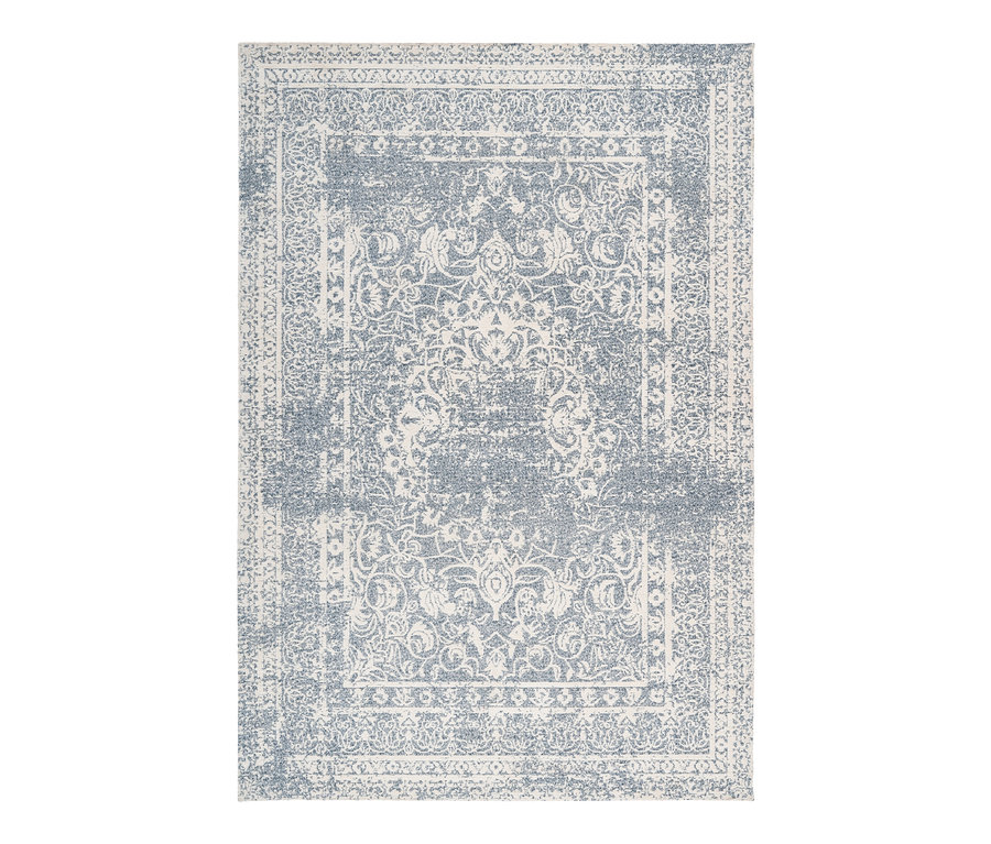 Detailaufnahme eines Kayoom Klassischer Jacquard-Teppichs »Iglesia 400« mit blau-cremefarbenem Blumenmuster.