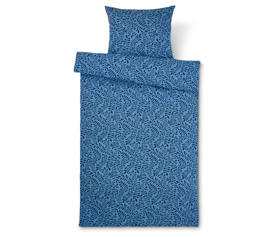 Blaue Bettwäsche mit Blättermuster und Kissen.