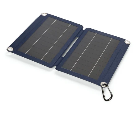 Aufgeklapptes blaues Solarpanel mit Karabinerhaken liegt auf einem weißen Untergrund.