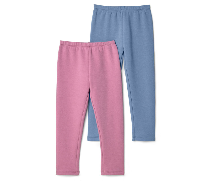 Eine rosafarbene Leggings liegt vor einer blauen Leggings auf einem weißen Hintergrund.