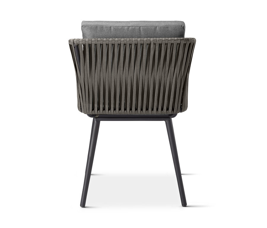 Rückansicht des Dining-Sessels »Jara« mit Textilgeflecht und grauem Kissen.