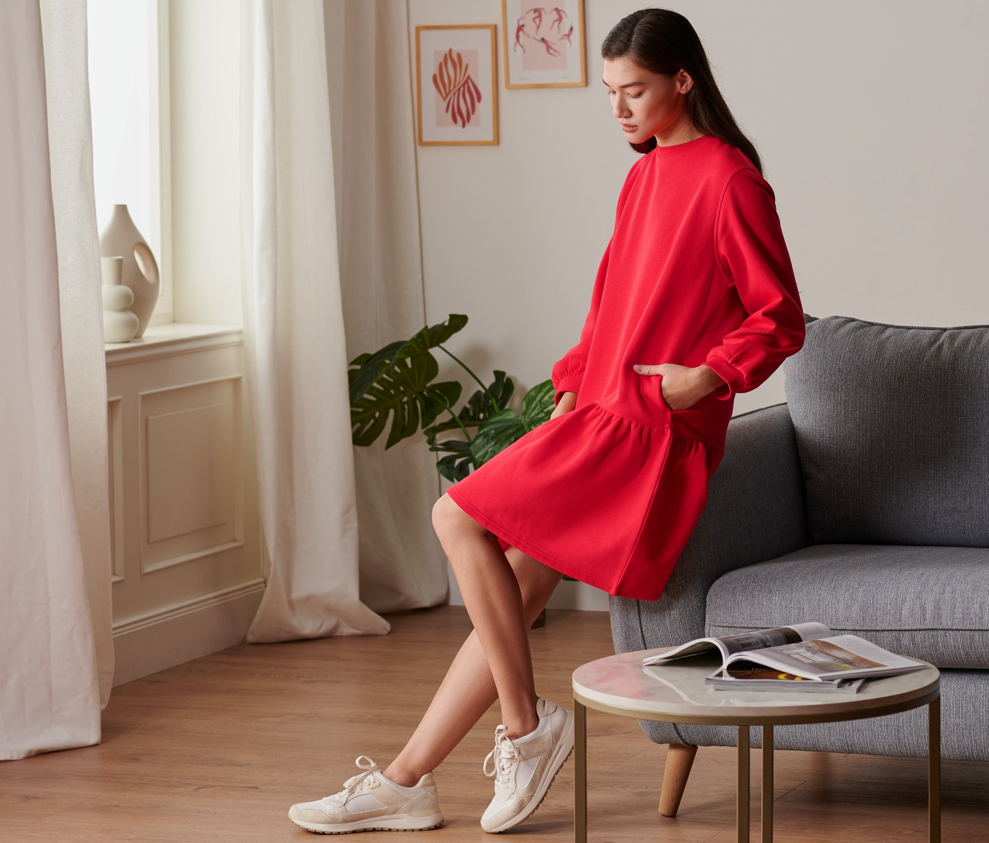 Frau posiert in rotem Sweatkleid.