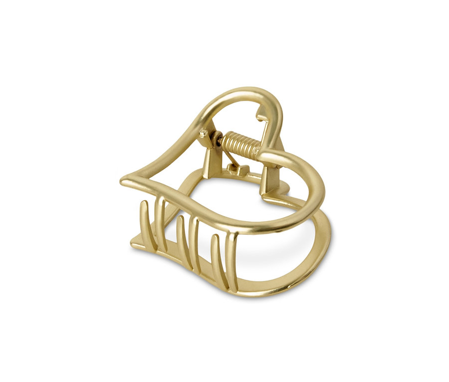 Goldene Haarklemme im Herzdesign.