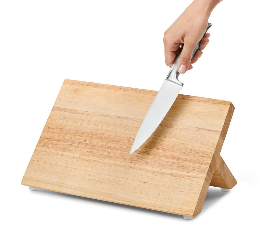 Eine Hand legt ein Messer an einen magnetischen Messerblock.