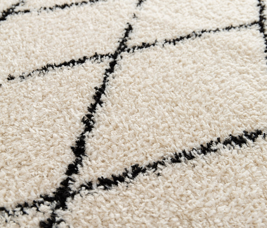 Nahaufnahme des Indoorteppichs »NOMAD Rhombus Line«, Ø ca. 160 cm mit Rautenmuster.