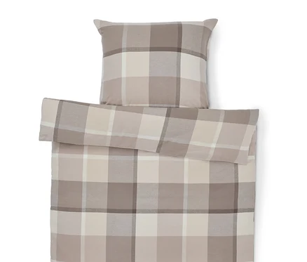 Bettbezug und Kissen mit Karomuster in Beige-Tönen.