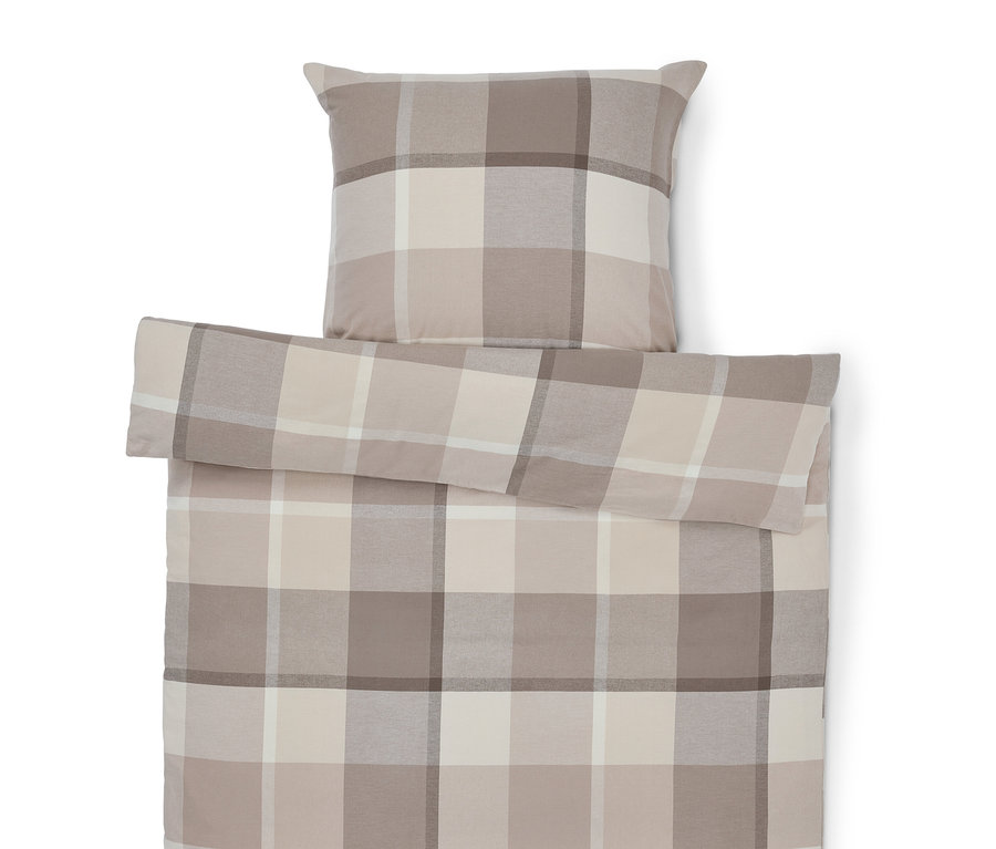 Bettbezug und Kissen mit Karomuster in Beige-Tönen.