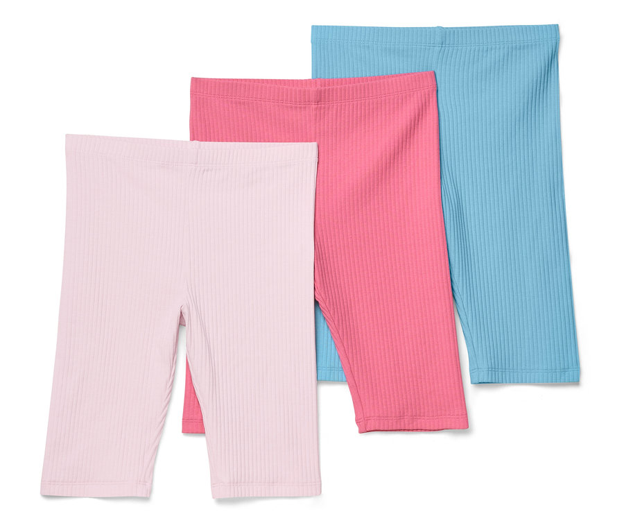 Drei gerippte Radlerhosen in Rosa-, Pink- und Blautönen liegen übereinander.