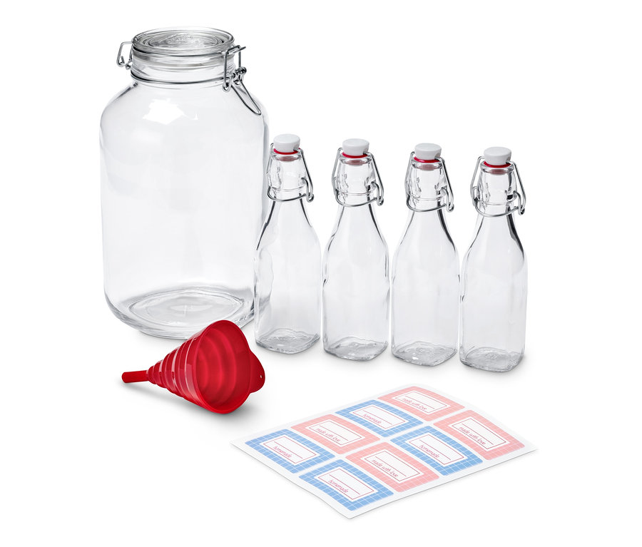 Das Likör-Ansatz-Set beinhaltet ein großes Glas, vier kleinere Flaschen, einen roten Trichter und einen Bogen mit Etiketten.